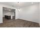 Dining room leading into the kitchen, featuring wood floors and chandelier at 10557 Sw 98Th Ln, Ocala, FL 34481