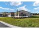 Lawn view showcasing the side of this beautifully landscaped single-story home with its freshly cut lawn at 10557 Sw 98Th Ln, Ocala, FL 34481