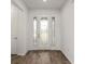 Bright foyer with decorative glass front door and hardwood flooring at 10557 Sw 98Th Ln, Ocala, FL 34481