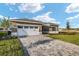 Attractive single-story home featuring a paved driveway, two-car garage, and well-maintained lawn at 10557 Sw 98Th Ln, Ocala, FL 34481