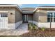 Close up of the covered front porch with a decorative glass front door and manicured landscaping at 10557 Sw 98Th Ln, Ocala, FL 34481