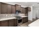 Close up of modern kitchen featuring stainless appliances, backsplash, and shaker style cabinets at 10557 Sw 98Th Ln, Ocala, FL 34481