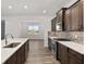 Gourmet kitchen features stainless appliances, backsplash and hardwood floors overlooking the living area at 10557 Sw 98Th Ln, Ocala, FL 34481