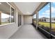 Spacious lanai with a ceiling and views of the yard, providing a seamless indoor-outdoor experience at 10557 Sw 98Th Ln, Ocala, FL 34481
