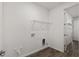 Bright laundry room with hookups, shelving and luxury vinyl flooring at 10557 Sw 98Th Ln, Ocala, FL 34481