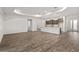 Open living space with hardwood floors, recessed lighting, and view of the modern kitchen at 10557 Sw 98Th Ln, Ocala, FL 34481