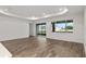 Spacious living room with hardwood floors, recessed lighting, and sliding glass doors to patio at 10557 Sw 98Th Ln, Ocala, FL 34481