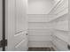 Pantry complete with multiple shelves for plenty of storage and luxury vinyl flooring at 10557 Sw 98Th Ln, Ocala, FL 34481