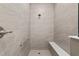 Bright shower with floor to ceiling tile, bench and shower head at 10557 Sw 98Th Ln, Ocala, FL 34481