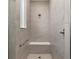Modern shower with tiled walls, a built-in seat, and sleek fixtures at 10557 Sw 98Th Ln, Ocala, FL 34481