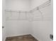 A walk-in closet with hardwood floors and shelving ready to be organized at 10557 Sw 98Th Ln, Ocala, FL 34481