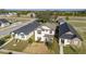 Aerial view of a two-story home with a well-maintained lawn at 10597 Grand Oaks Blvd, Oxford, FL 34484