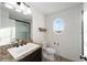 Bathroom features oval window, granite countertops, and walk-in shower at 10597 Grand Oaks Blvd, Oxford, FL 34484