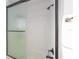 Modern bathroom featuring a glass shower with white subway tile and bronze fixtures at 10597 Grand Oaks Blvd, Oxford, FL 34484