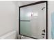Second bathroom featuring shower/tub combo with sliding glass door and updated fixtures at 10597 Grand Oaks Blvd, Oxford, FL 34484