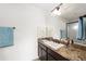 Well-lit bathroom featuring granite countertops, vanity, and a glass-enclosed shower at 10597 Grand Oaks Blvd, Oxford, FL 34484