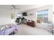 Neutral-toned bedroom with bright natural light, ceiling fan and large windows at 10597 Grand Oaks Blvd, Oxford, FL 34484