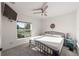 Bright and airy bedroom featuring a ceiling fan and view of the outdoors at 10597 Grand Oaks Blvd, Oxford, FL 34484