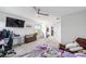 Bright and airy bedroom features a ceiling fan and view of the outdoors at 10597 Grand Oaks Blvd, Oxford, FL 34484