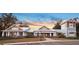 Beautiful community clubhouse with manicured landscaping and ample parking at sunset at 10597 Grand Oaks Blvd, Oxford, FL 34484
