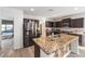 Beautiful kitchen features stainless steel appliances, granite countertops, and a central island at 10597 Grand Oaks Blvd, Oxford, FL 34484