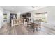 Eat-in kitchen featuring an island with seating, granite countertops, and modern appliances at 10597 Grand Oaks Blvd, Oxford, FL 34484