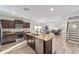 Open concept kitchen with modern appliances flows into the dining and living areas at 10597 Grand Oaks Blvd, Oxford, FL 34484