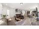 Open-concept living area showcases a staircase, modern floors, and seamless flow to the kitchen at 10597 Grand Oaks Blvd, Oxford, FL 34484