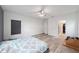 Spacious bedroom featuring a ceiling fan, large window, and access to the ensuite bathroom at 10597 Grand Oaks Blvd, Oxford, FL 34484