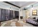Enclosed patio with stone floors, ceiling fan, curtains, and outdoor furniture at 10597 Grand Oaks Blvd, Oxford, FL 34484
