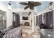 Enclosed patio with stone floors, ceiling fan, curtains, and outdoor furniture at 10597 Grand Oaks Blvd, Oxford, FL 34484