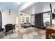 Enclosed patio with stone floors, ceiling fan, curtains, and outdoor furniture at 10597 Grand Oaks Blvd, Oxford, FL 34484
