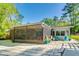 Home's screened-in lanai and outdoor seating area with peaceful backyard view at 11720 Cherokee Cir, Dunnellon, FL 34431