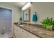 Bright bathroom features white cabinets, granite countertop, framed mirror, and green walls at 11720 Cherokee Cir, Dunnellon, FL 34431