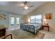 Bright bedroom with high ceilings and an ornate bed, features double doors to the patio at 11720 Cherokee Cir, Dunnellon, FL 34431