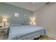 Airy bedroom with pastel walls features a decorative white iron bed frame and two side tables at 11720 Cherokee Cir, Dunnellon, FL 34431