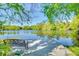 Bench on a private dock overlooking the serene lake and surrounding greenery at 11720 Cherokee Cir, Dunnellon, FL 34431