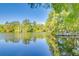 Picturesque lake view with a wooden dock and clear blue sky at 11720 Cherokee Cir, Dunnellon, FL 34431