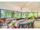 A spacious screened-in patio with comfortable seating provides stunning views of the lake at 11720 Cherokee Cir, Dunnellon, FL 34431