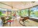 This screened-in patio offers lovely views of the lake and a relaxing seating area at 11720 Cherokee Cir, Dunnellon, FL 34431