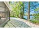 Tiled patio overlooking the tranquil lake surrounded by mature trees at 11720 Cherokee Cir, Dunnellon, FL 34431
