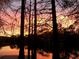Beautiful sunset reflecting on the lake, visible from the property at 11720 Cherokee Cir, Dunnellon, FL 34431