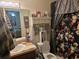 Standard bathroom with a floral shower curtain and functional layout at 11860 Nw 18Th Pl, Ocala, FL 34482