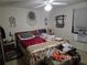 Untidy bedroom with bed, nightstand, and ceiling fan at 11860 Nw 18Th Pl, Ocala, FL 34482