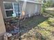 Modest, one-story home with a brown exterior and simple landscaping at 11860 Nw 18Th Pl, Ocala, FL 34482