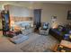 Cozy living room with couches, recliner, carpet and a large area rug at 11860 Nw 18Th Pl, Ocala, FL 34482