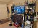 Comfortable living area with fireplace, TV, and built-in shelving at 11860 Nw 18Th Pl, Ocala, FL 34482