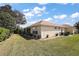 Expansive backyard showing manicured lawn and tidy landscaping with an expansive screened-in lanai at 12133 Se 91St Ter, Summerfield, FL 34491