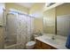 Well-lit bathroom featuring a shower-tub combo, a white toilet, and a wooden vanity at 12133 Se 91St Ter, Summerfield, FL 34491