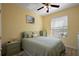 Cozy bedroom with yellow walls, a full-size bed, and a window offering natural light at 12133 Se 91St Ter, Summerfield, FL 34491